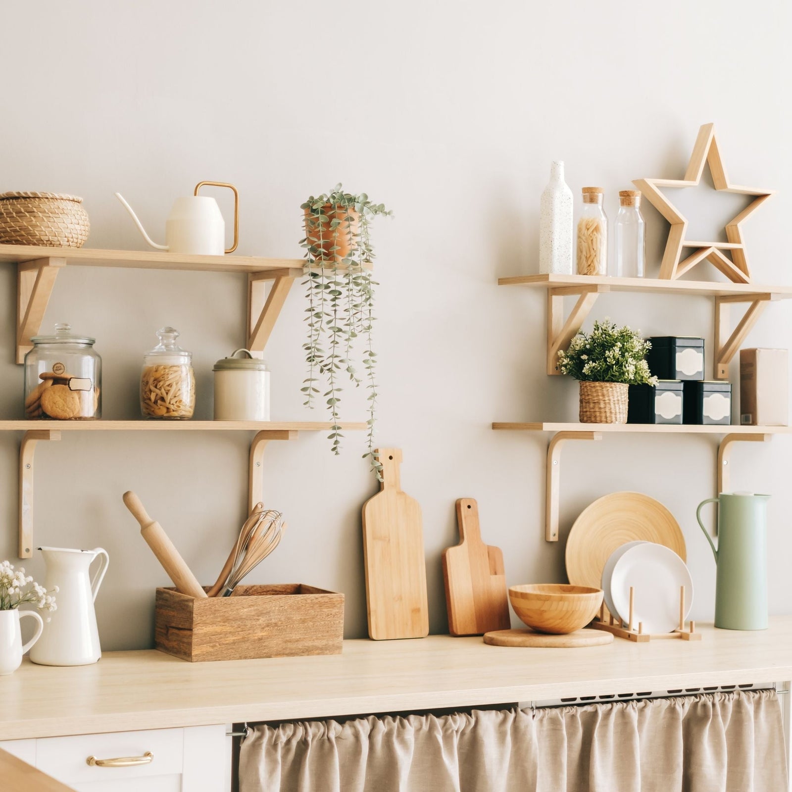Minimalist kitchen shelves with wooden decor, cutting boards, storage jars, and plants for a natural and organized kitchen space.
