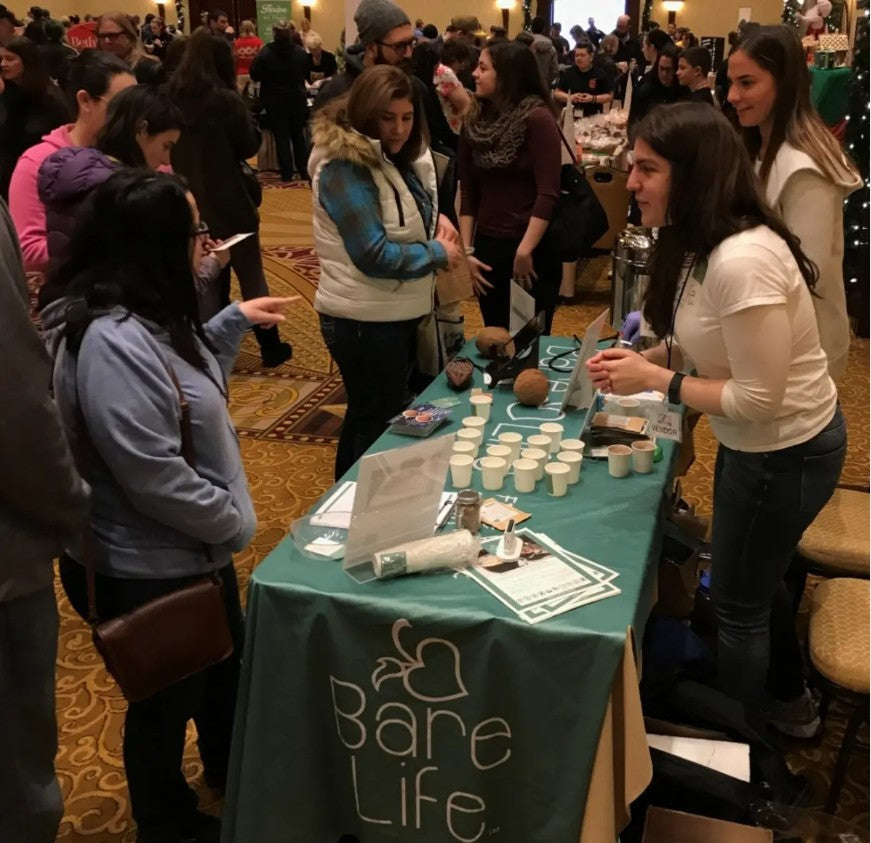 Ali Lazowski sampling Bare Life hot cocoa at an event.