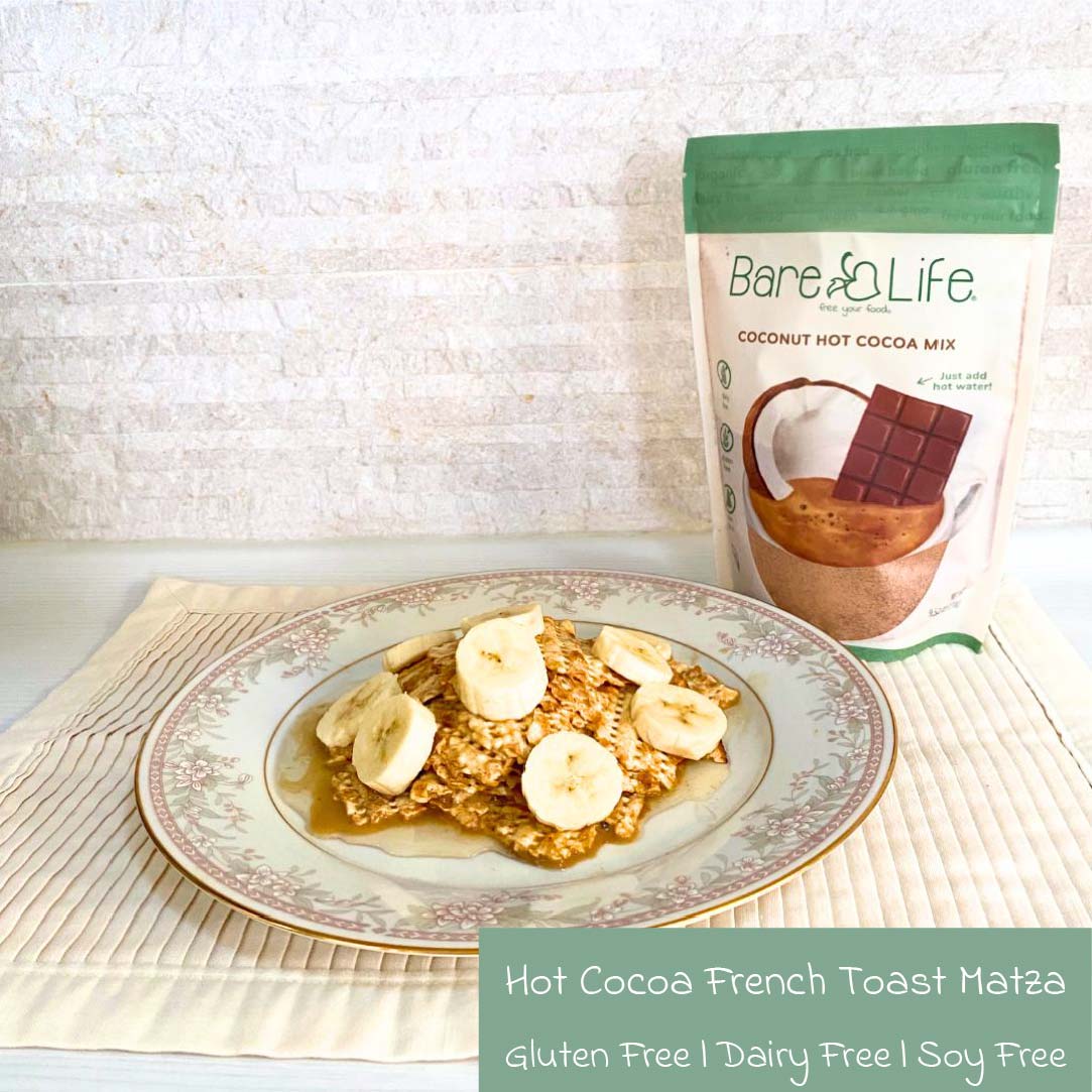 Banana slices on a plate of gluten-free matza French toast made with dairy-free and refined sugar-free hot cocoa mix, served with maple syrup on a floral-patterned dish for a better-for-you Passover breakfast