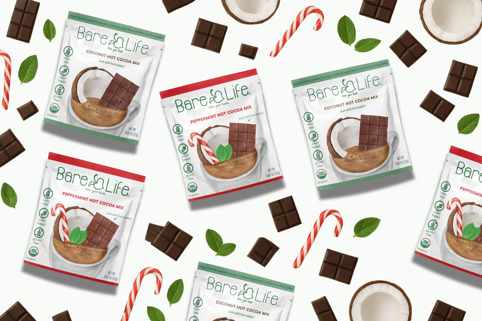 Bare Life Dairy Free and Organic hot cocoa mix packages with chocolate pieces and candy canes on a white background
